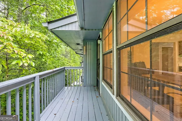 a view of a balcony with wooden floor