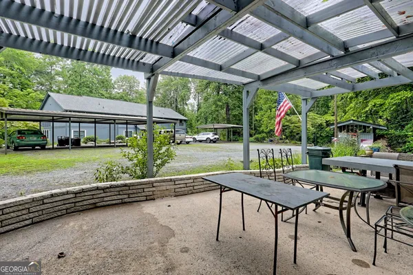 a view of a patio with a table chairs and a backyard