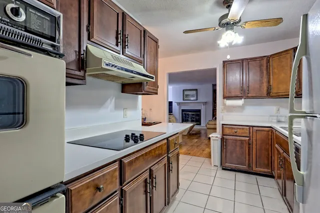 a kitchen with stainless steel appliances granite countertop a sink and cabinets