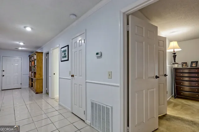 a view of a hallway with closet and livingroom view