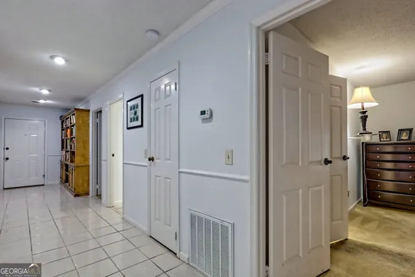 a view of a hallway with closet and livingroom view