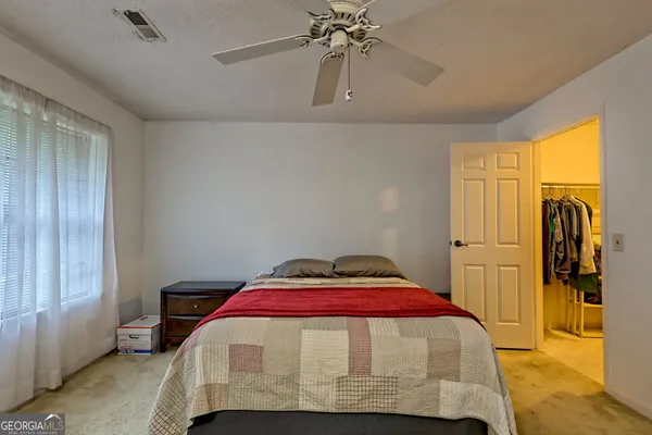 a bedroom with a bed and a window