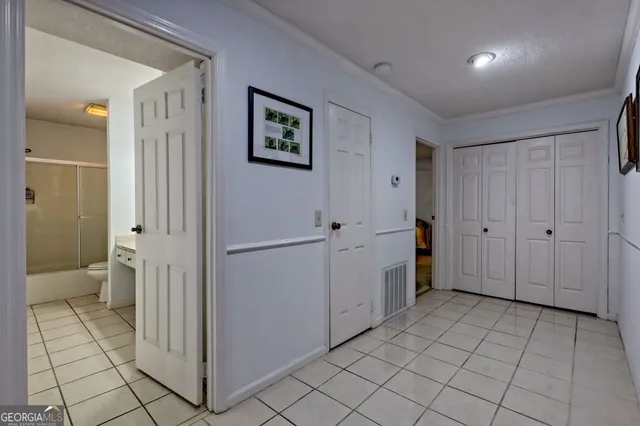 a view of a hallway to rooms