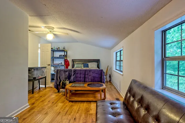 a bed sitting in a bedroom next to a window