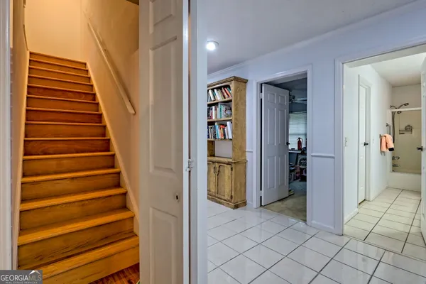 a view of a hallway with entryway and stairs