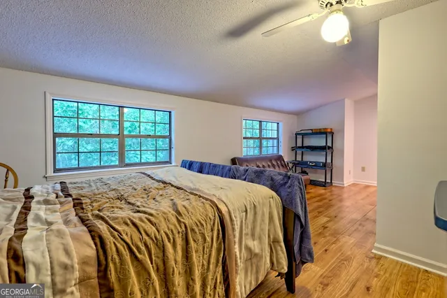 a bathroom with a granite countertop toilet and a sink