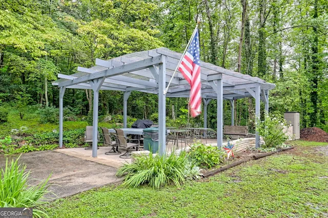 a view of a patio with a table chairs and a backyard