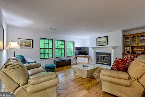 a living room with furniture fireplace and a window