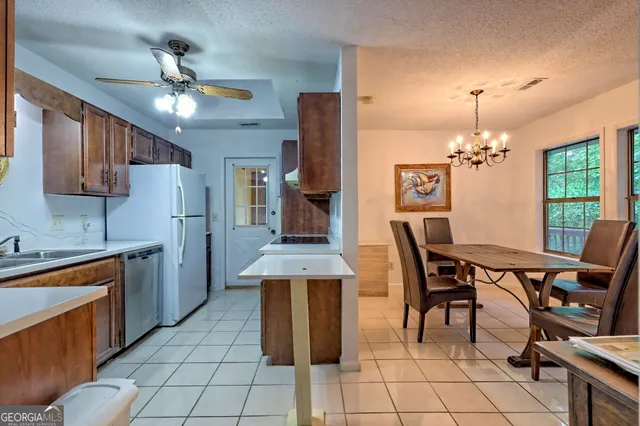 a view of kitchen with furniture and chandelier