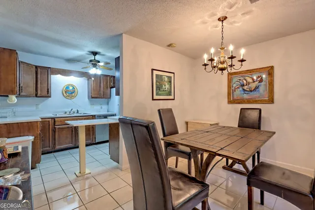 a view of a dining room with furniture and a chandelier