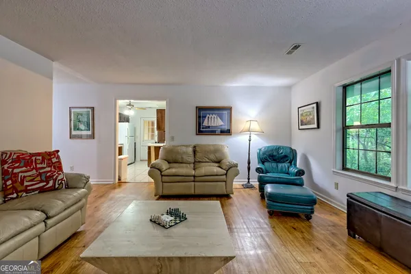 a living room with furniture window and wooden floor
