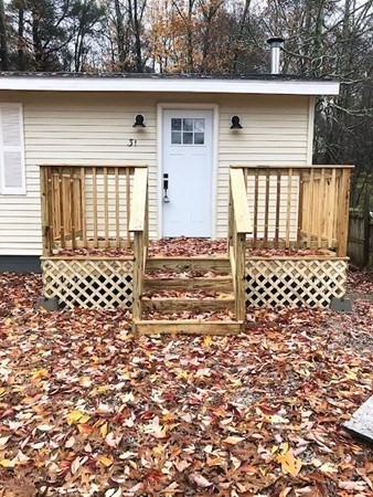 31 Richie Road Douglas, MA 01516 - Photo 2 of 16 a front view of a house with a black gate