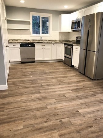 31 Richie Road Douglas, MA 01516 - Photo 4 of 16 a large kitchen with granite countertop a refrigerator and a stove