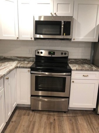 31 Richie Road Douglas, MA 01516 - Photo 6 of 16 a kitchen with a stove and a microwave