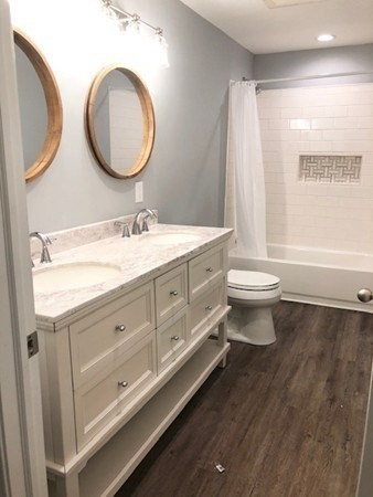 31 Richie Road Douglas, MA 01516 - Photo 7 of 16 a bathroom with a toilet a sink a mirror and a window