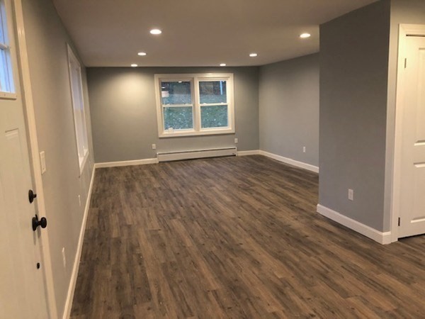 31 Richie Road Douglas, MA 01516 - Photo 8 of 16 an empty room with wooden floor and windows