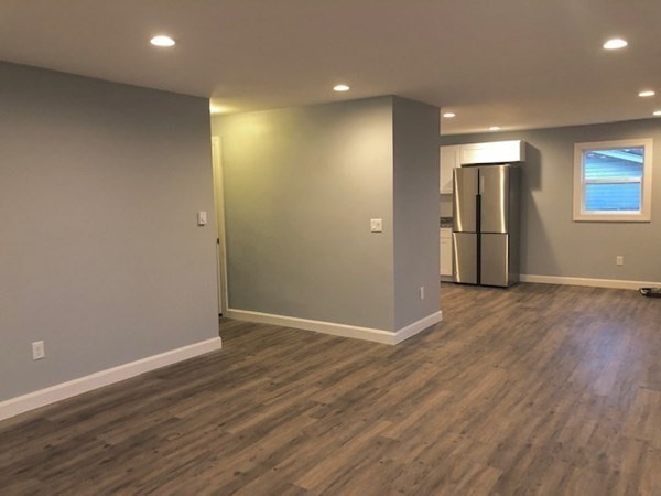 31 Richie Road Douglas, MA 01516 - Photo 9 of 16 an empty room with wooden floor and windows