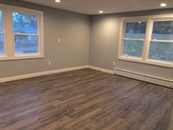 31 Richie Road Douglas, MA 01516 - Photo 10 of 16 an empty room with wooden floor and windows