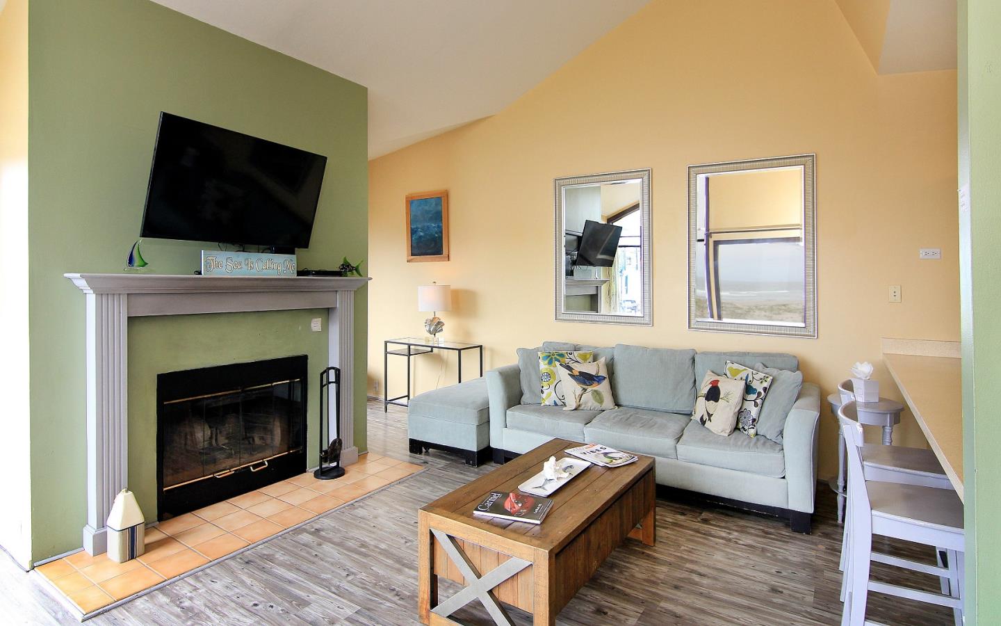 66 Pelican Point Watsonville, CA 95076 - Photo 11 of 30 a living room with furniture a flat screen tv and a fireplace