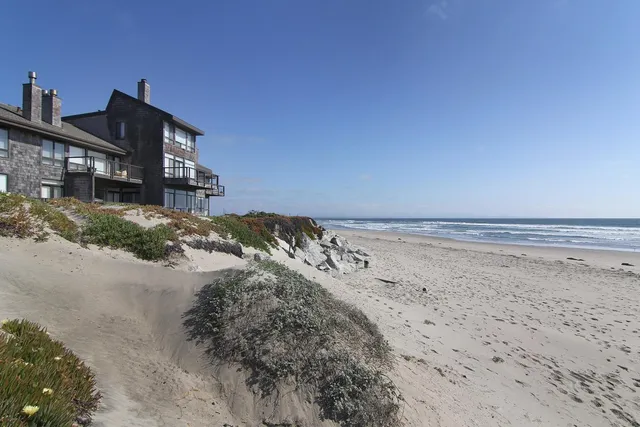 a view of a street with a house in the background