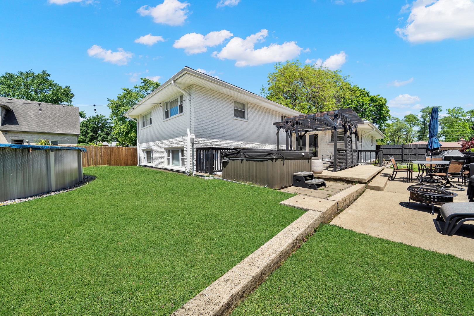 9737 West 57th Street Countryside, IL 60525 - Photo 19 of 19 a view of a house with backyard sitting area and garden