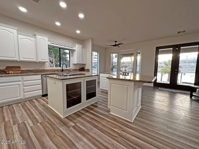 a kitchen with a stove top oven and cabinets