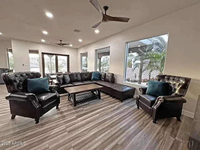 a living room with furniture and a wooden floor