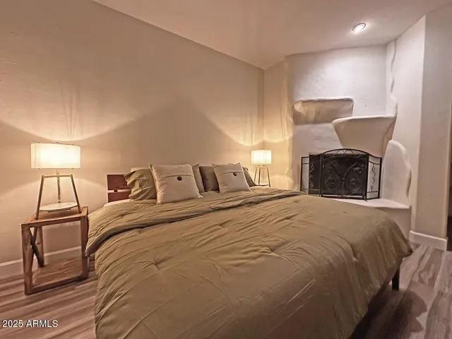 a bedroom with a bed and a lamp