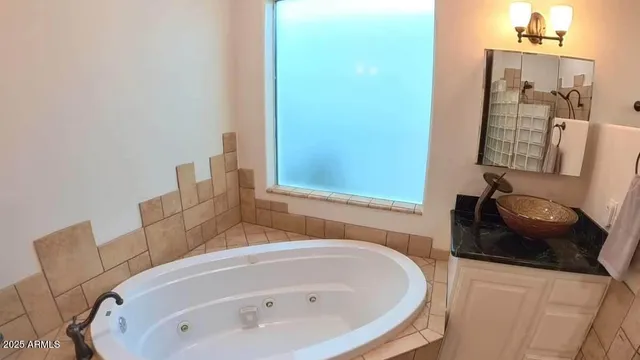 a bathroom with a tub and sink