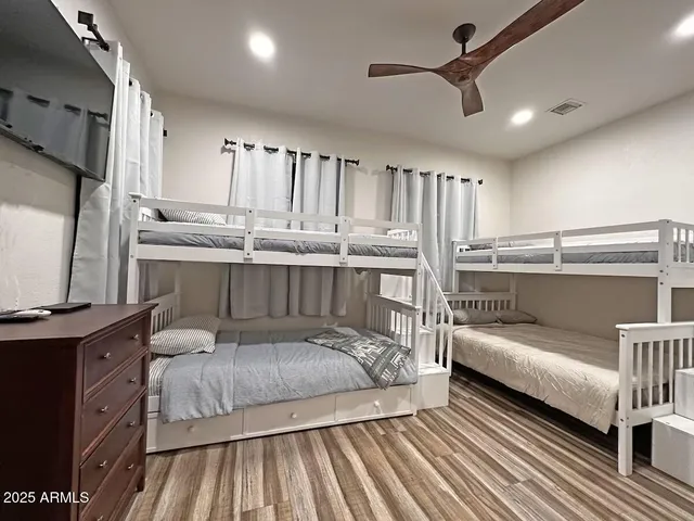 a bedroom with a bed window and a table