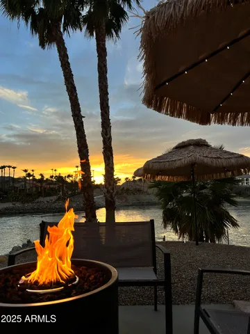 a view of a balcony with chairs and a potted plant