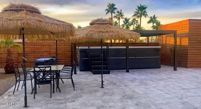 a view of a chairs and table in backyard