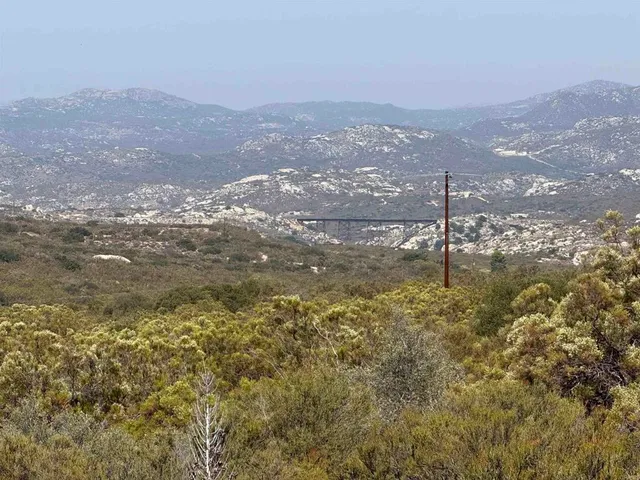 a view of a town with mountains in the background