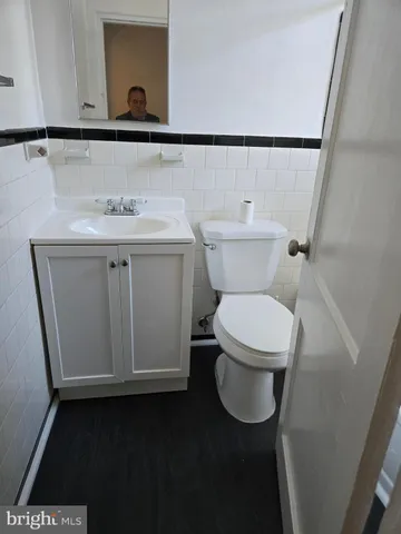 a white toilet sitting next to a bathroom sink