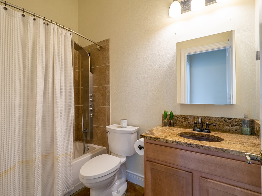 3609 Clawson Road, Unit B Austin, TX 78704 - Photo 23 of 28 Full bathroom featuring a single vanity with a granite countertop, undermount sink, and a dark bronze faucet
