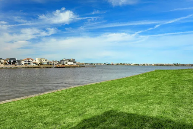 a view of a lake with houses in the back