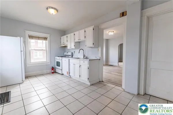 a kitchen with stainless steel appliances a sink and cabinets