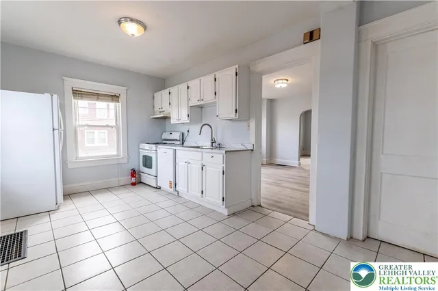 a kitchen with stainless steel appliances a sink and cabinets