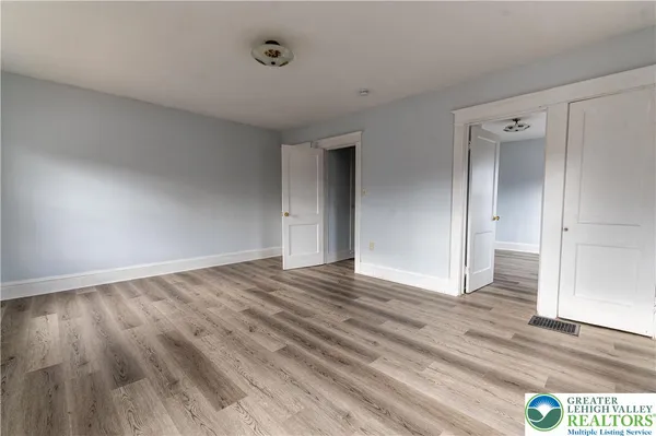 a view of an empty room and wooden floor