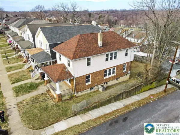 an aerial view of a house with a yard