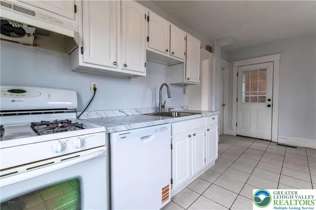 a kitchen with appliances cabinets and a sink