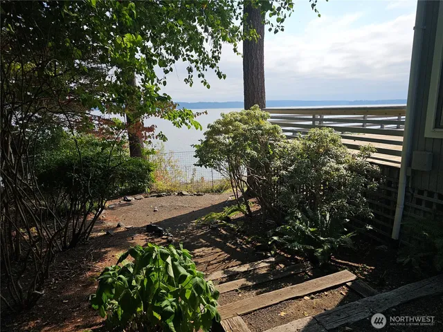a side view of a house with a yard