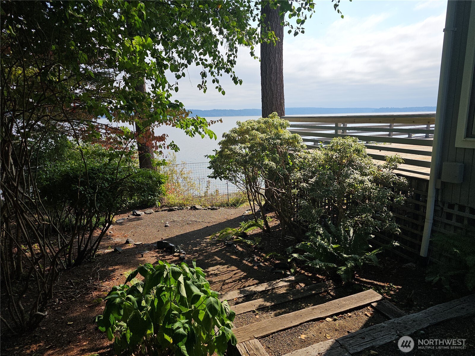 70 East Sund Road Grapeview, WA 98546 - Photo 20 of 36 a view of a yard with plants and a bench