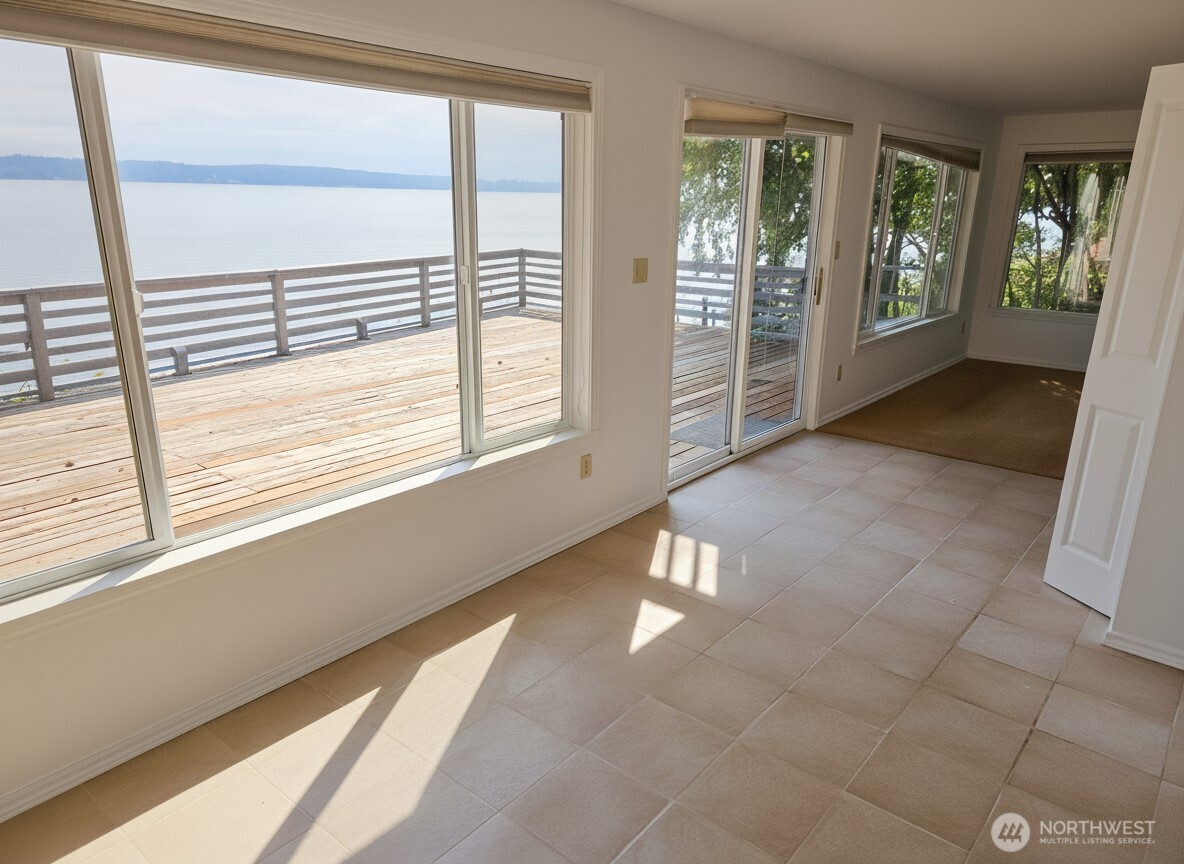 70 East Sund Road Grapeview, WA 98546 - Photo 9 of 36 a view of an empty room with wooden floor and a window