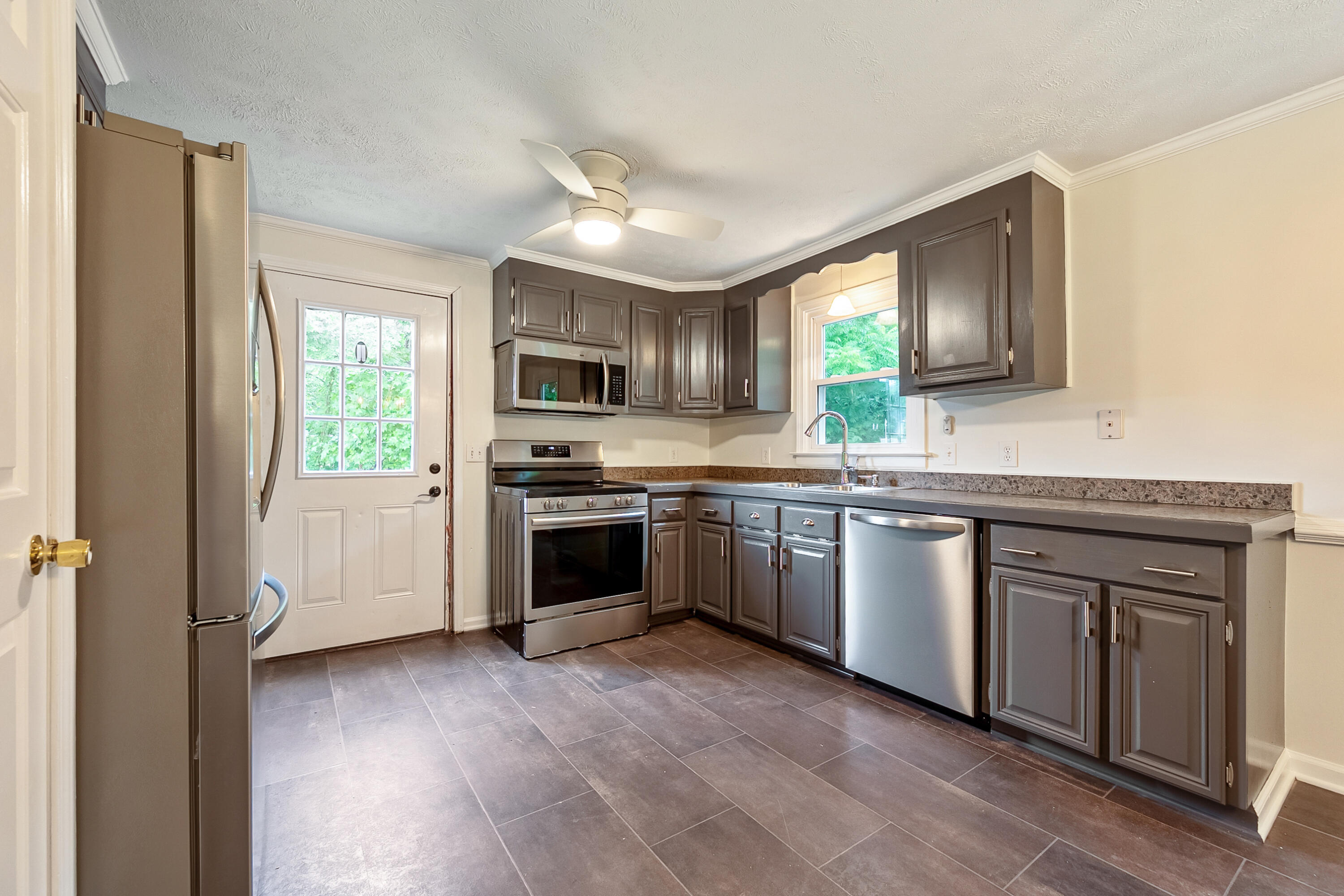 281 Penn Road Northwest Floyd, VA 24091 - Photo 9 of 49 a kitchen with granite countertop a sink cabinets stainless steel appliances and a window