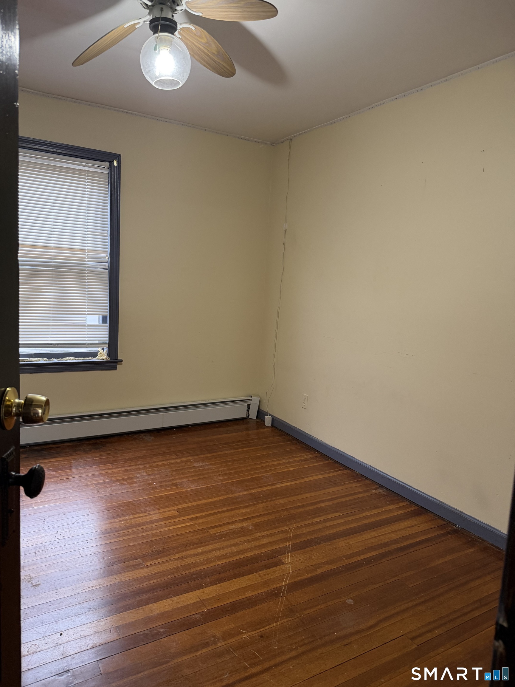 16 St Lawrence Street Manchester, CT 06040 - Photo 3 of 6 an empty room with wooden floor and windows