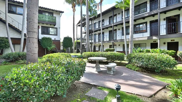 a view of a building with garden and sitting area