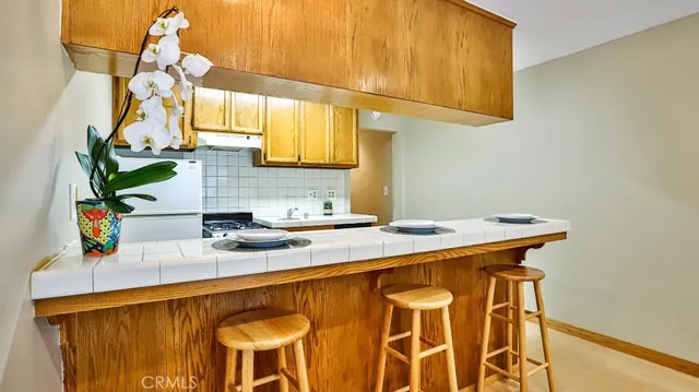 a kitchen with a sink cabinets and a window