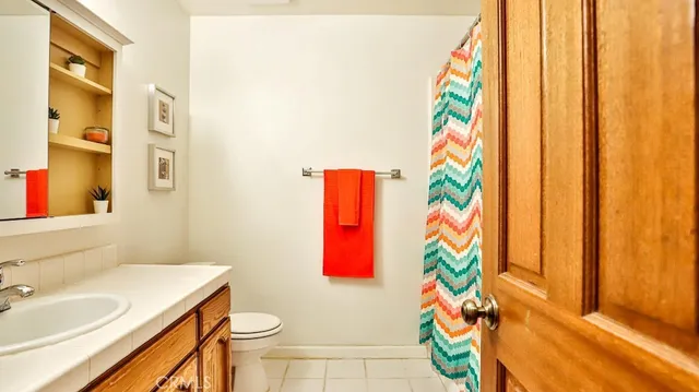 a bathroom with a sink a mirror and a shower curtain