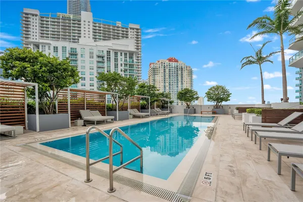 a swimming pool with outdoor seating and yard